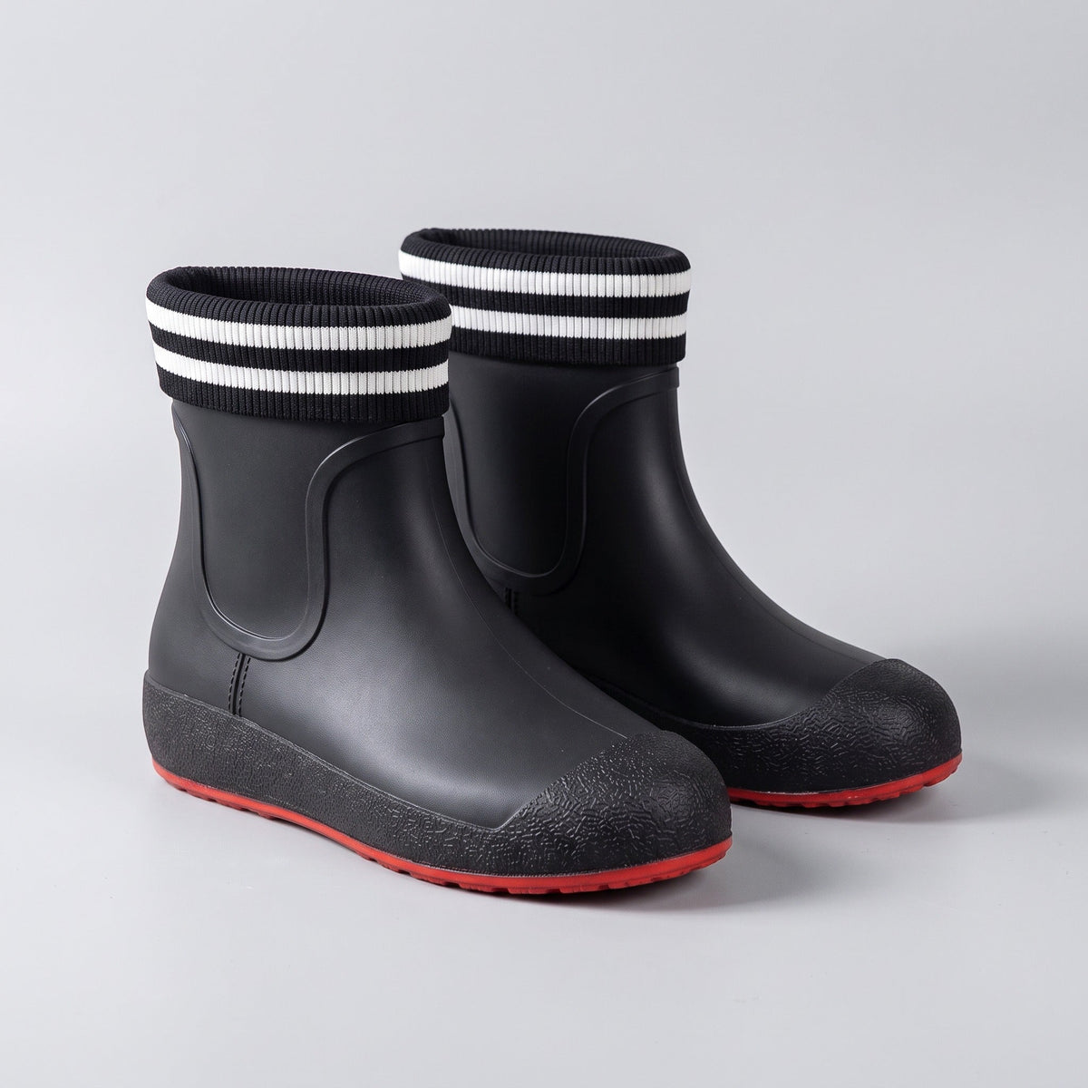 Black ankle wellies with striped cuffs and red soles, shown unworn | Chaps London