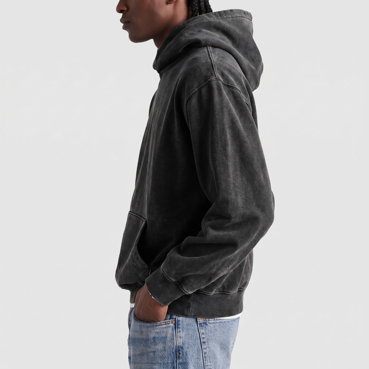 Man wearing oversized washed black hoodie with kangaroo pocket, side view | Chaps London