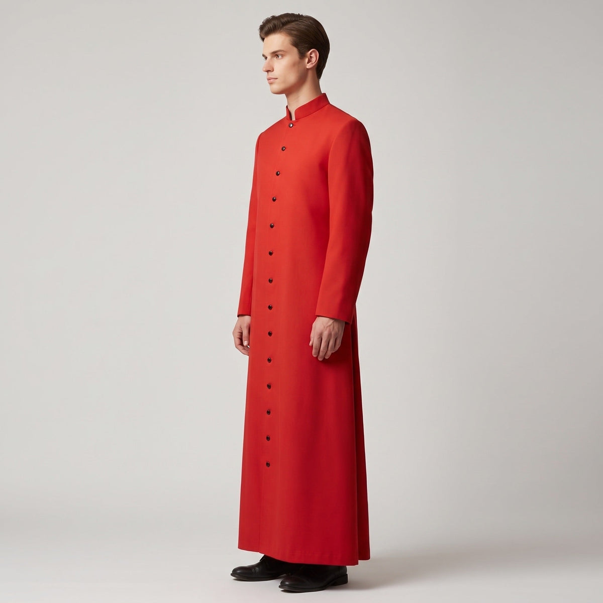 Man wearing long red button-front cassock with stand collar, side view | Chaps London