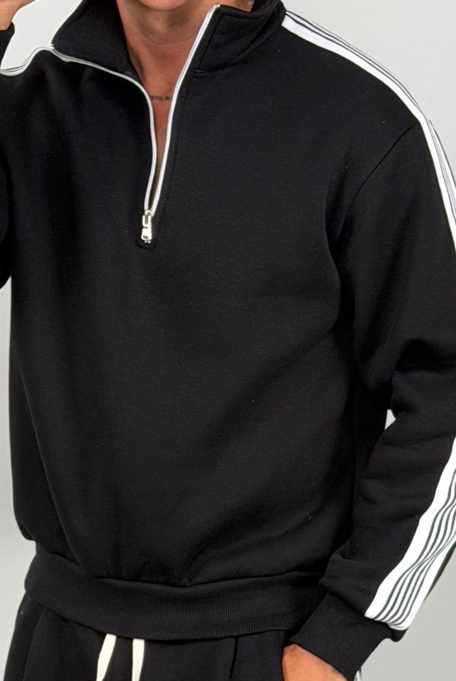 Man wearing black half zip tracksuit top with white striped sleeves | Chaps London