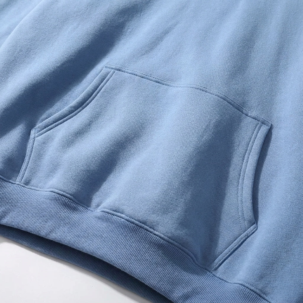 Close-up of blue hoodie fabric with kangaroo pocket and ribbed hem | Chaps London