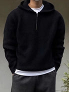 Men's half-zip knit hoodie in black, worn, front view