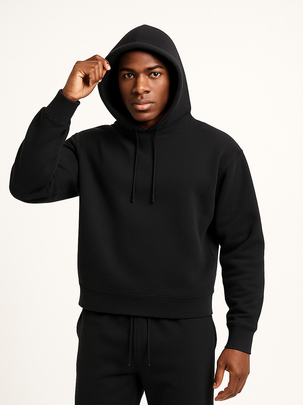 Men's relaxed-fit hoodie in black, worn, front view