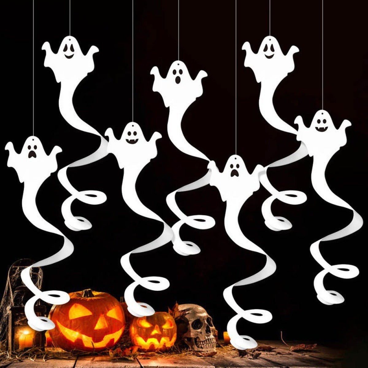 Hanging ghosts above pumpkins as Halloween decoration