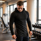 Men's slim-fit gym hoodie in black, worn in the gym