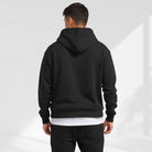 Men's oversized drop-shoulder hoodie in black, worn, back view