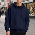Men's oversized zip-up hoodie in navy, worn, front view