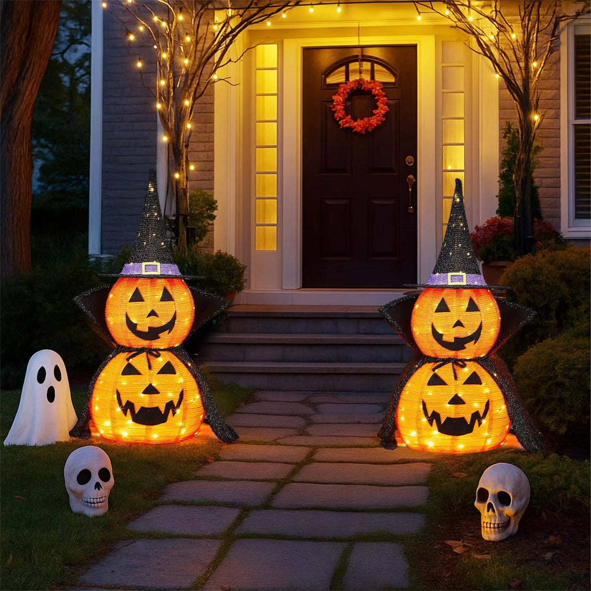 Two light-up pumpkins along the garden path to the front door