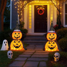 Two light-up pumpkins along the garden path to the front door