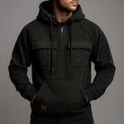 Men's half-zip utility hoodie with chest pockets in black, worn, front view