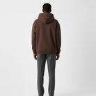 Men's heavyweight hoodie in dark brown, worn, back view