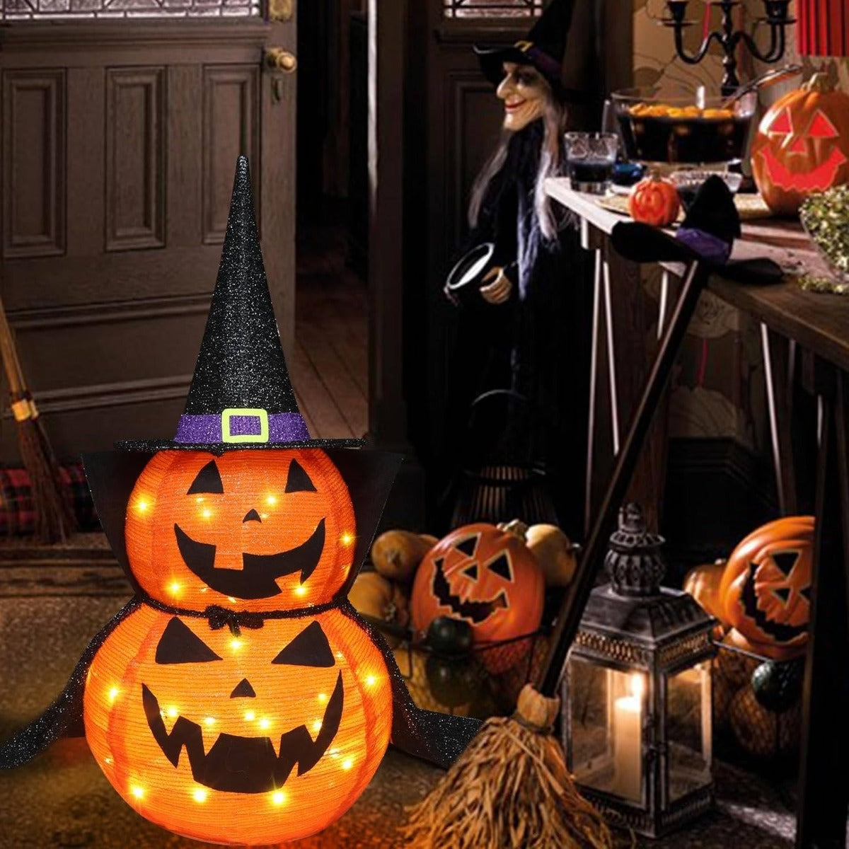 Lit pumpkin with witch hat next to the front door