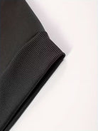 Men's soft-lined winter hoodie in black, close-up of the ribbed cuff