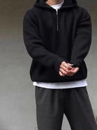 Men's half-zip knit hoodie in black, worn, front view