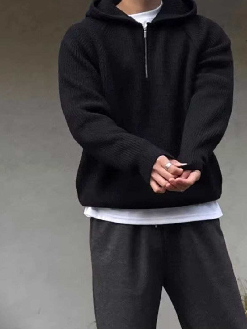 Men's half-zip knit hoodie in black, worn, front view