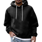 Men's oversized hoodie in black, worn, front view