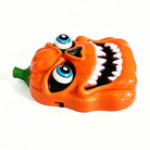 Glossy orange jack-o-lantern toy with blue eyes, toothy grin, standalone product shot | Chaps London
