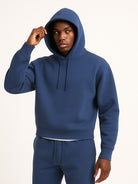 Men's relaxed-fit hoodie in blue, worn, front view