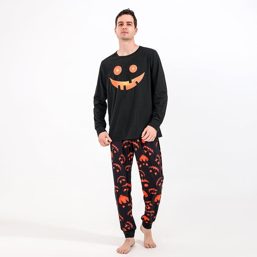 Man wearing the black Halloween pyjamas with a jack-o'-lantern face