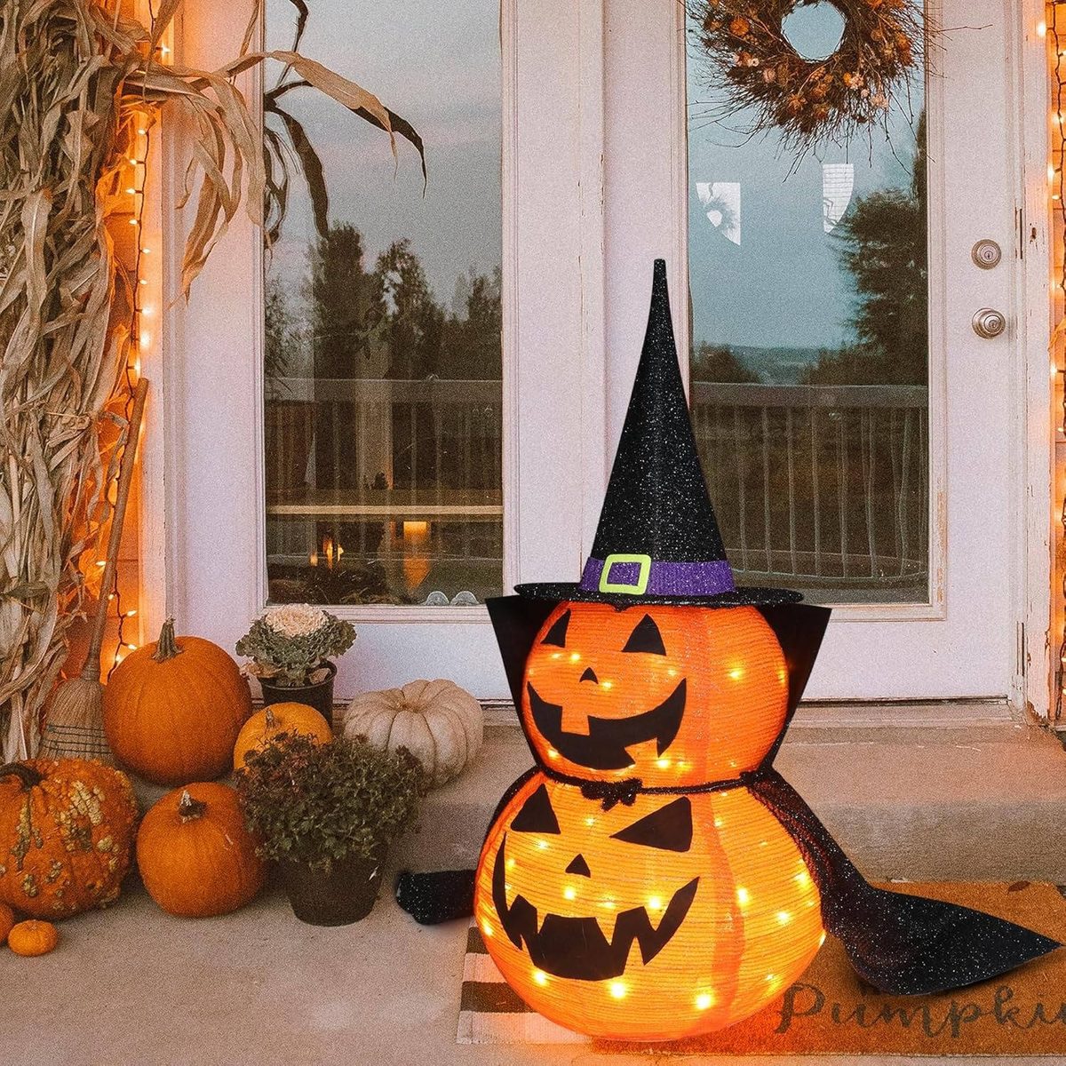 Pumpkin decoration with witch hat by the front door