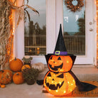 Pumpkin decoration with witch hat by the front door