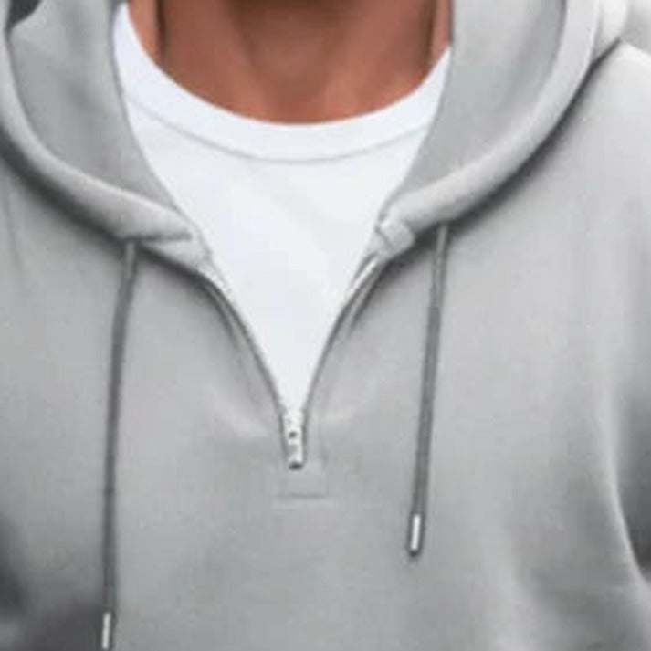 Men's quarter-zip hoodie in grey, close-up of the short zip and the drawstrings