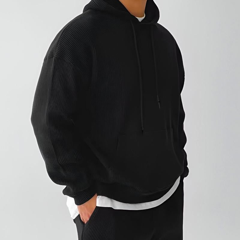 Men's ribbed oversized hoodie in black, worn, side view