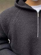 Men's half-zip knit hoodie in dark grey, close-up of the fine knit and the half zip