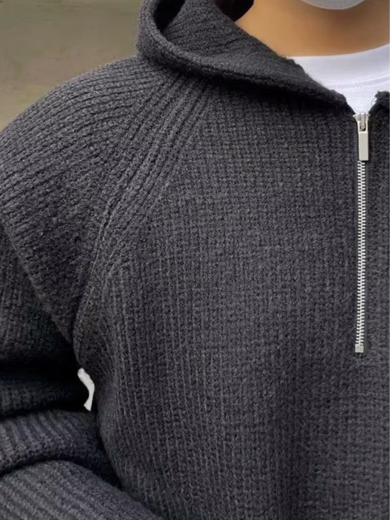 Men's half-zip knit hoodie in dark grey, close-up of the fine knit and the half zip