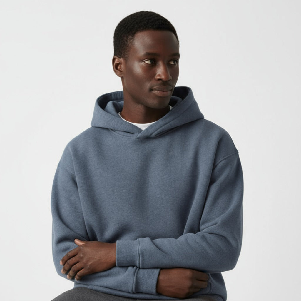 Men's heavyweight hoodie in washed blue, worn, seated