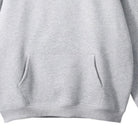 Men's oversized pullover hoodie in light grey, close-up of the kangaroo pocket