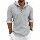 Men's waffle henley hoodie in light grey, worn, front view