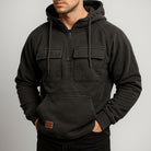 Men's half-zip utility hoodie with chest pockets in dark grey, worn, front view