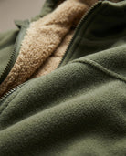 Men's sherpa-lined zip-up fleece in army green, close-up of the sherpa lining and the zip