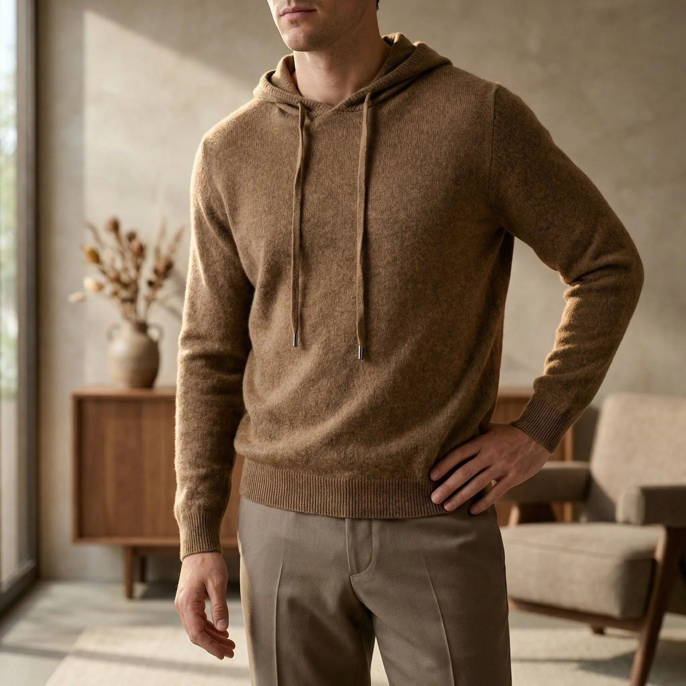 Men's fine-knit hooded jumper in brown, worn in a living room