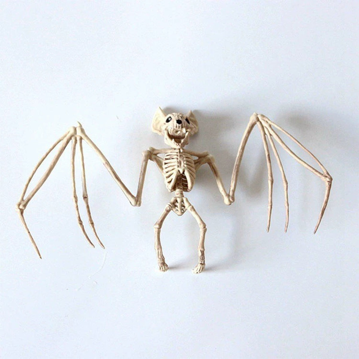 Bat skeleton figurine, beige plastic, posable wings, flat on white background | Chaps London