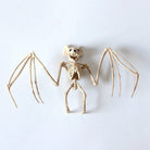Bat skeleton figurine, beige plastic, posable wings, flat on white background | Chaps London