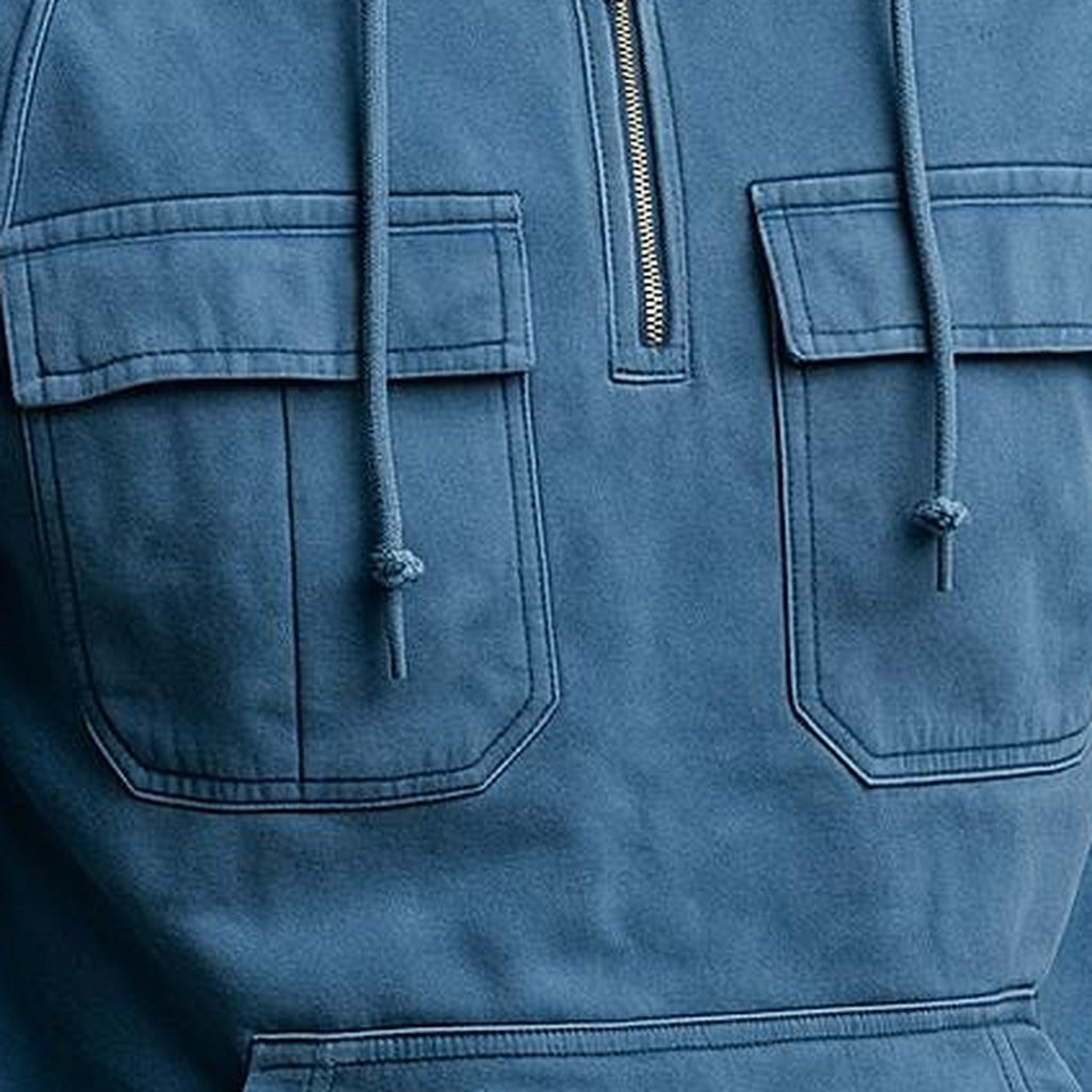 Men's half-zip utility hoodie with chest pockets in blue, close-up of the chest pockets, the half zip and the drawstrings
