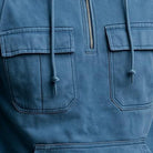 Men's half-zip utility hoodie with chest pockets in blue, close-up of the chest pockets, the half zip and the drawstrings