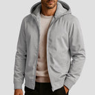 Men's sherpa-lined zip hoodie in light grey, worn, front view