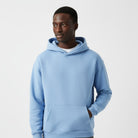 Men's heavyweight hoodie in light blue, worn, front view