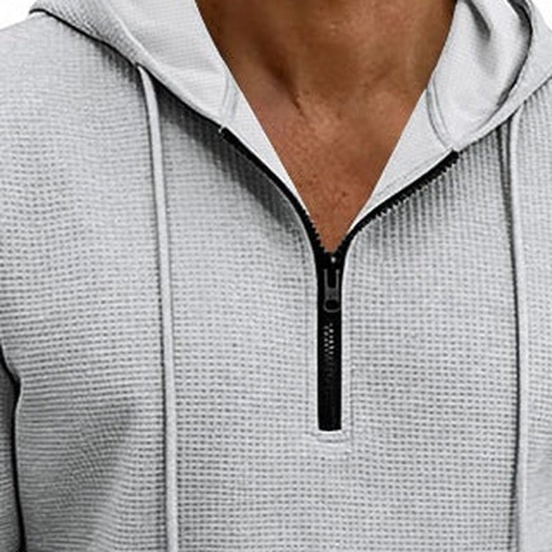 Men's textured quarter-zip hoodie in light grey, close-up of the short zip, the drawstrings and the waffle texture