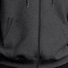 Men's oversized zip-up hoodie in dark grey, close-up of the kangaroo pocket and the zip