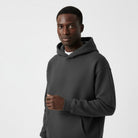Men's heavyweight hoodie in dark grey, worn, front view