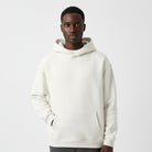 Men's heavyweight hoodie in white, worn, front view