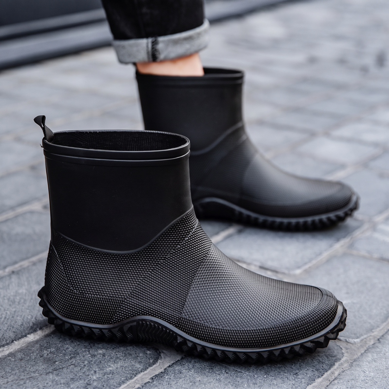 Black rubber ankle boots for men, worn on the street