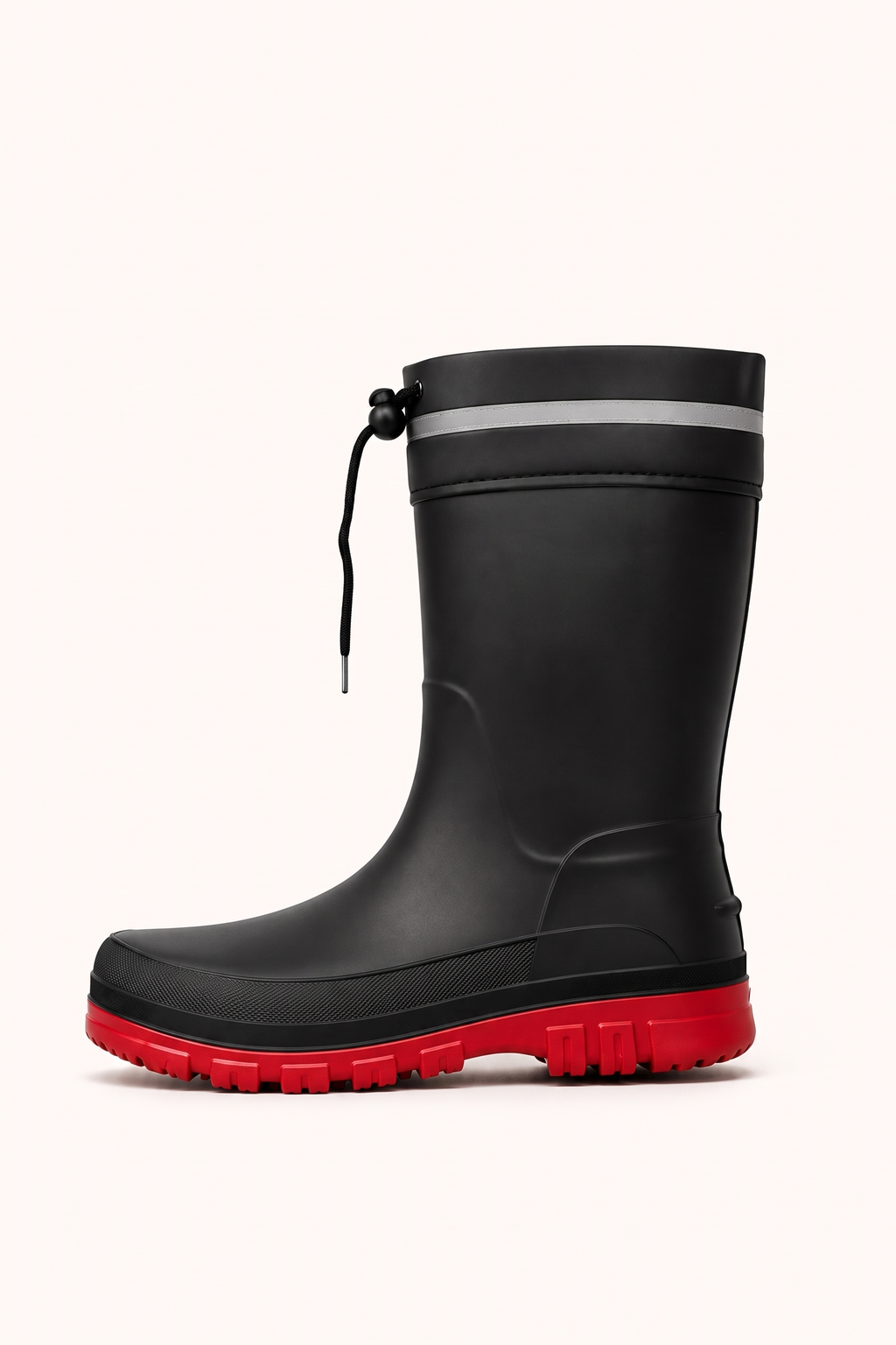 Side view of a black mid calf rain boot with a red lugged sole, a reflective band and a drawstring at the top.