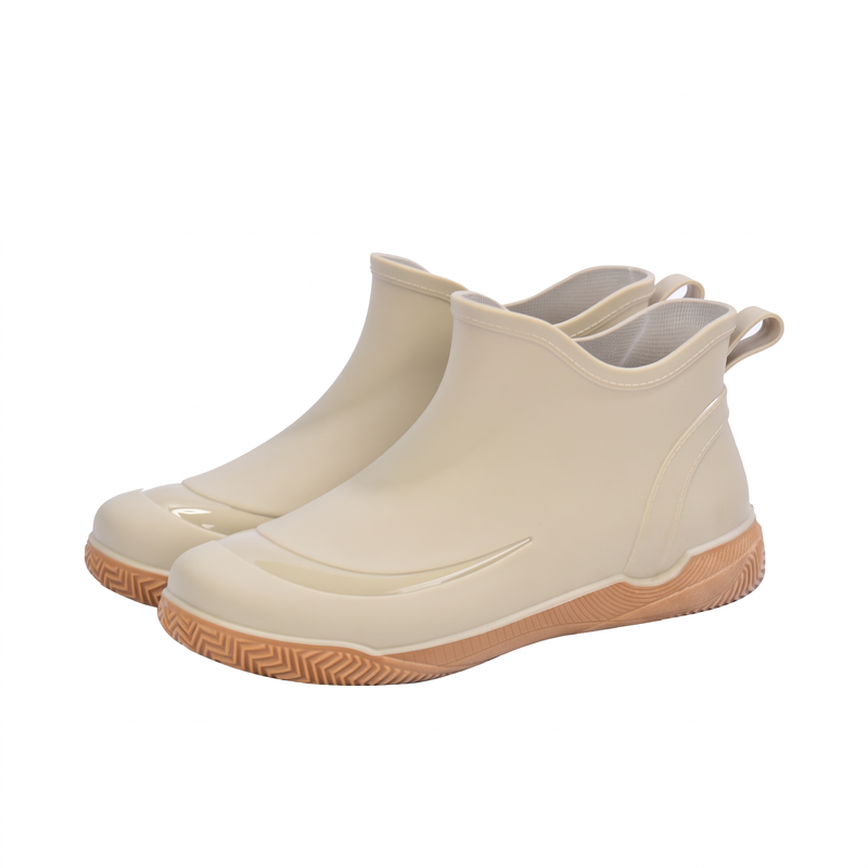 Pair of beige short wellies with tan treaded soles