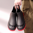 Black wellies with red soles, front view