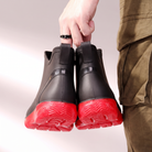 Black wellies with red soles and pull tabs, back view